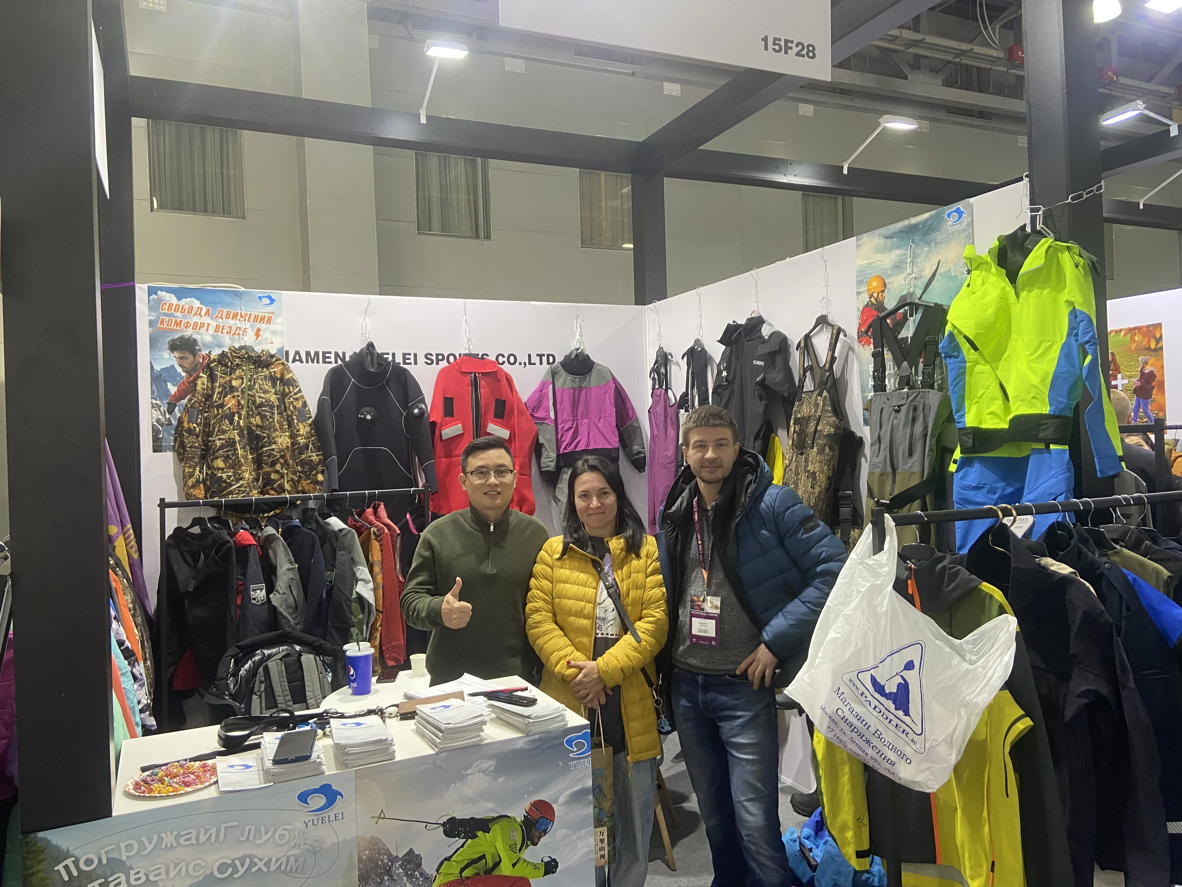 Tianxuan team with visitors at an outdoor apparel trade show